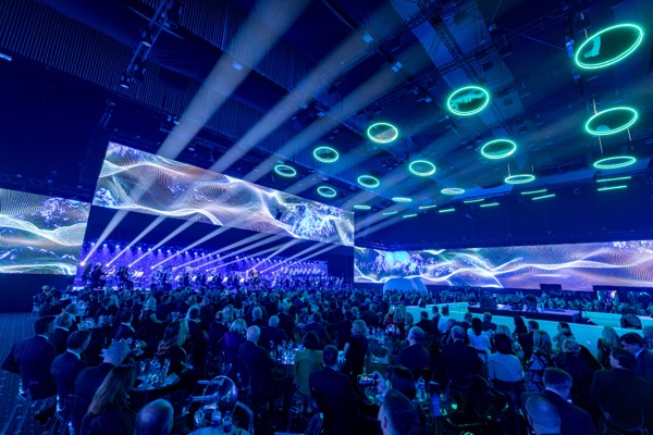 Summit event with live orchestra performing alongside generative visuals